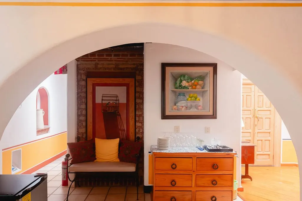 Round arch leading into a room with an exposed brick wall