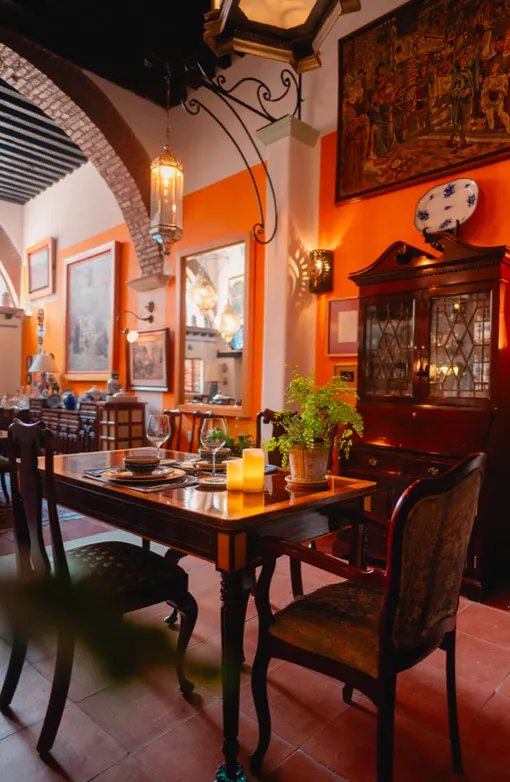 Dining corner with brick arch, lantern and antique cabinet