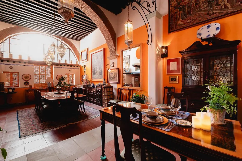 Dining area under a brick arch with a wrought-iron lantern