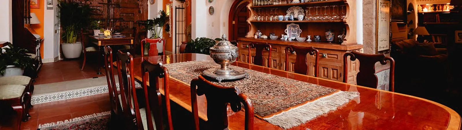 Panoramic view of the dining room with silver tureen and Talavera pottery