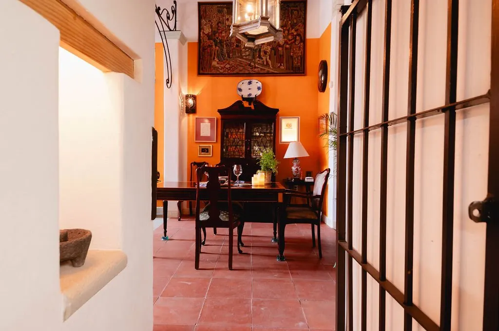 The dining room seen through a wrought-iron grille