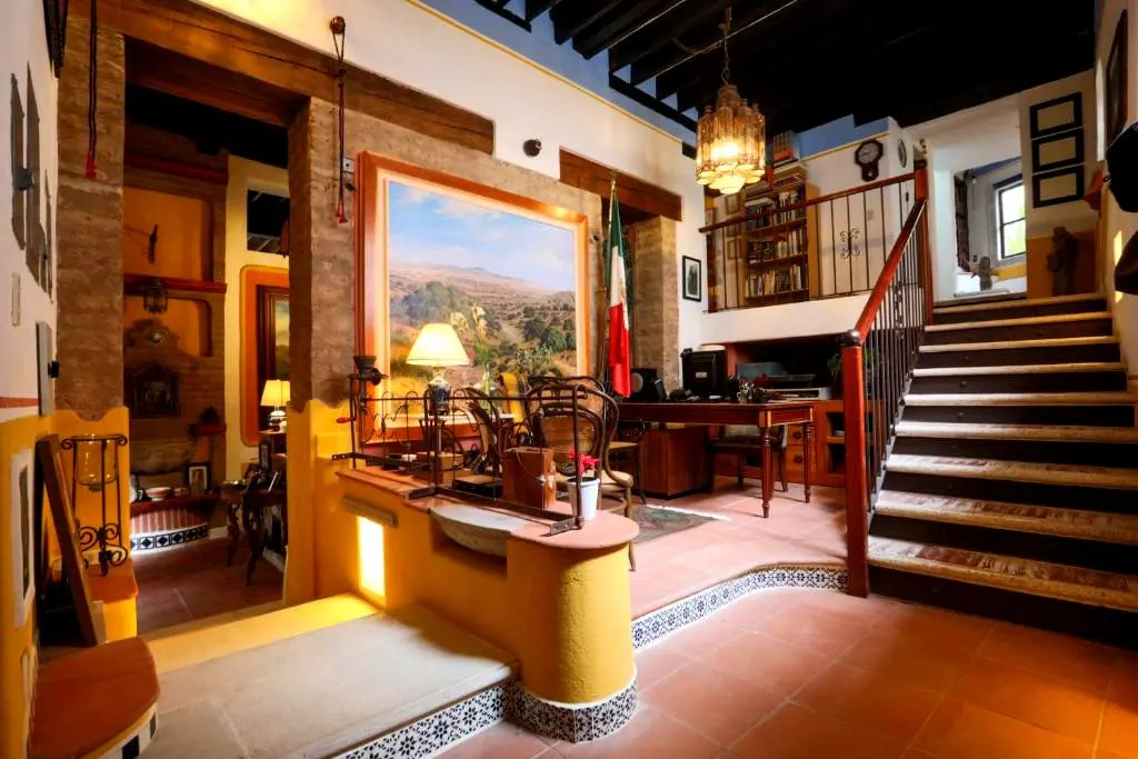 Reception with staircase, chandelier and landscape painting