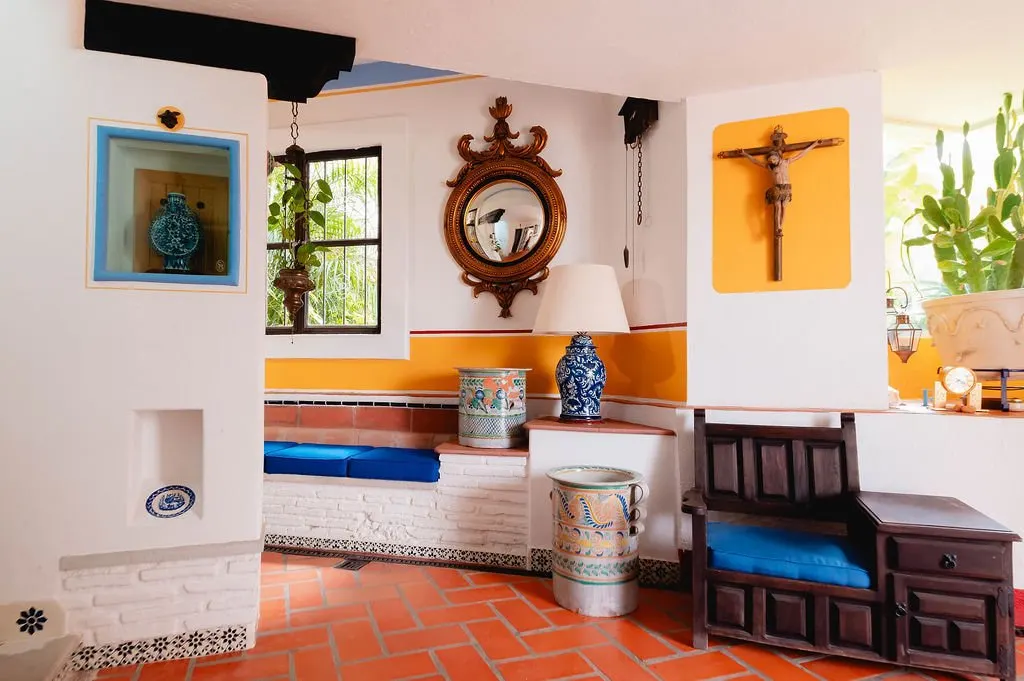 Nook with a blue bench, Talavera vases and sunburst mirror