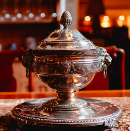 Engraved silver tureen on the dining table