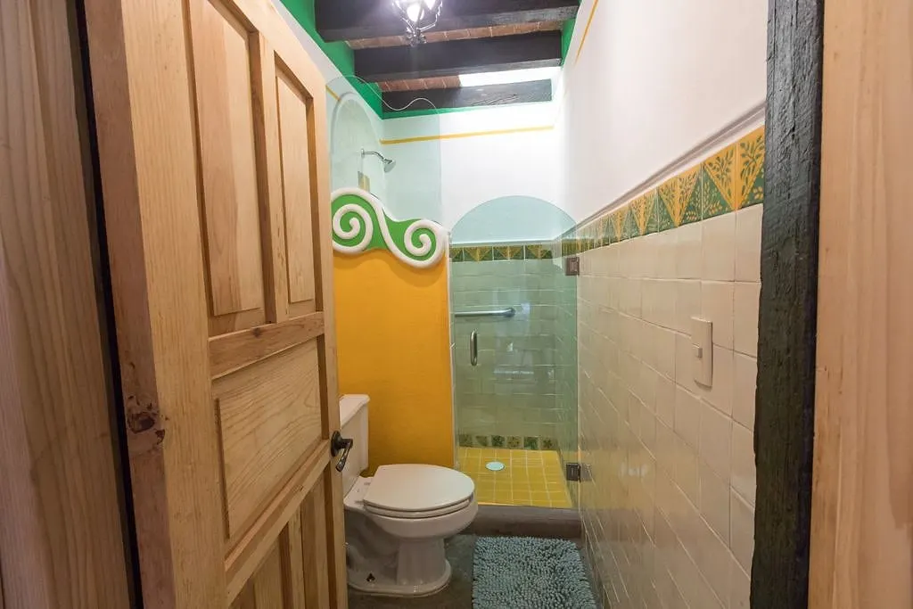 Los Picachos suite bathroom with a glass shower and yellow tiles