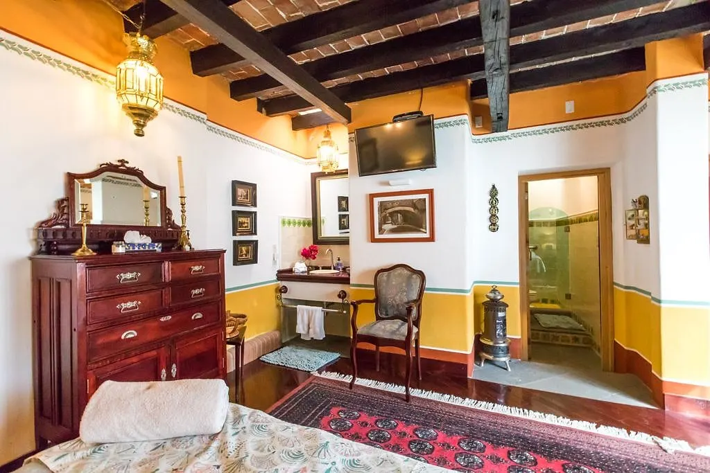 Antique dresser with mirror and lantern in the Los Picachos suite