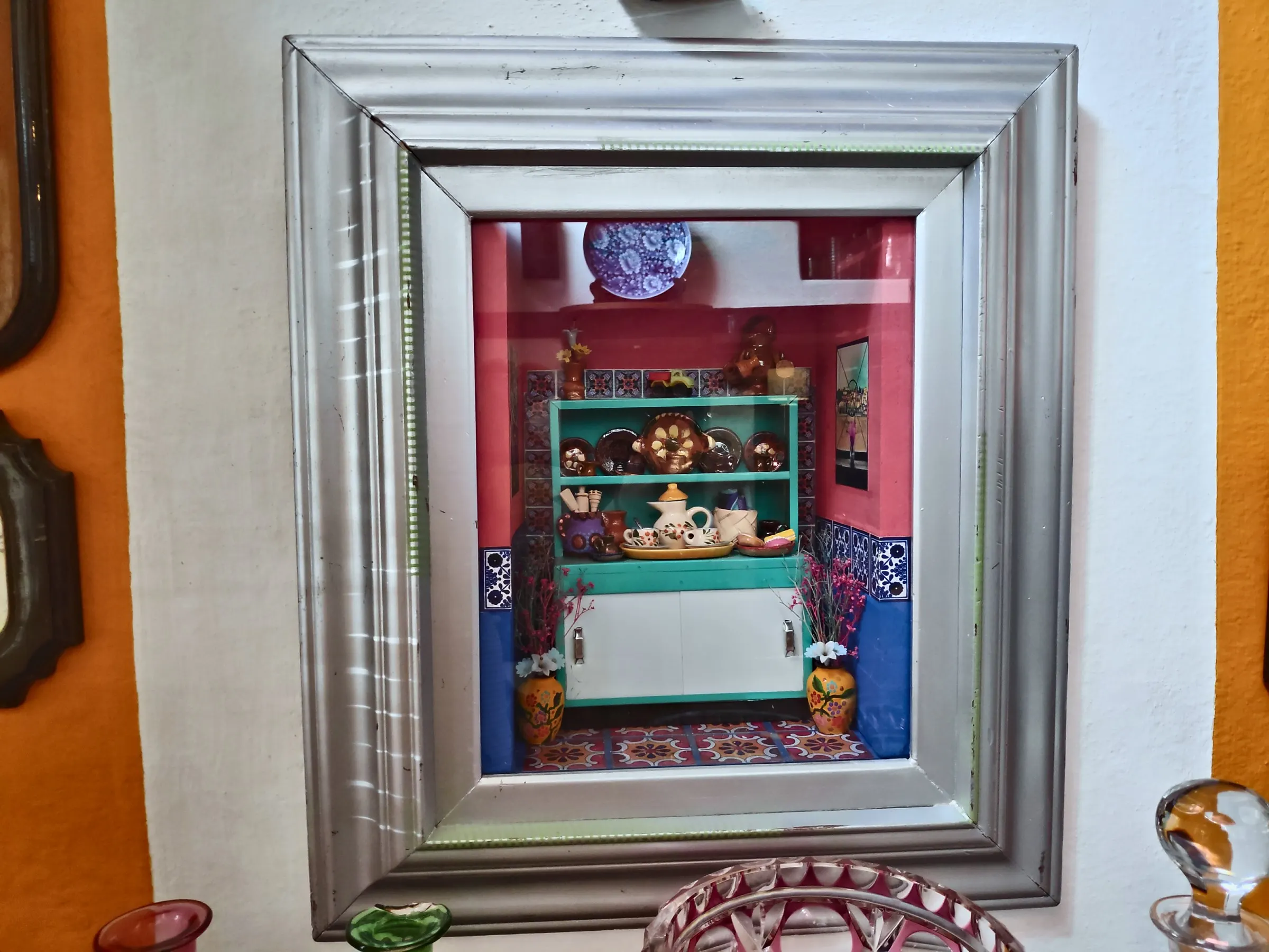 Shadow box with a miniature Mexican kitchen in a silver frame